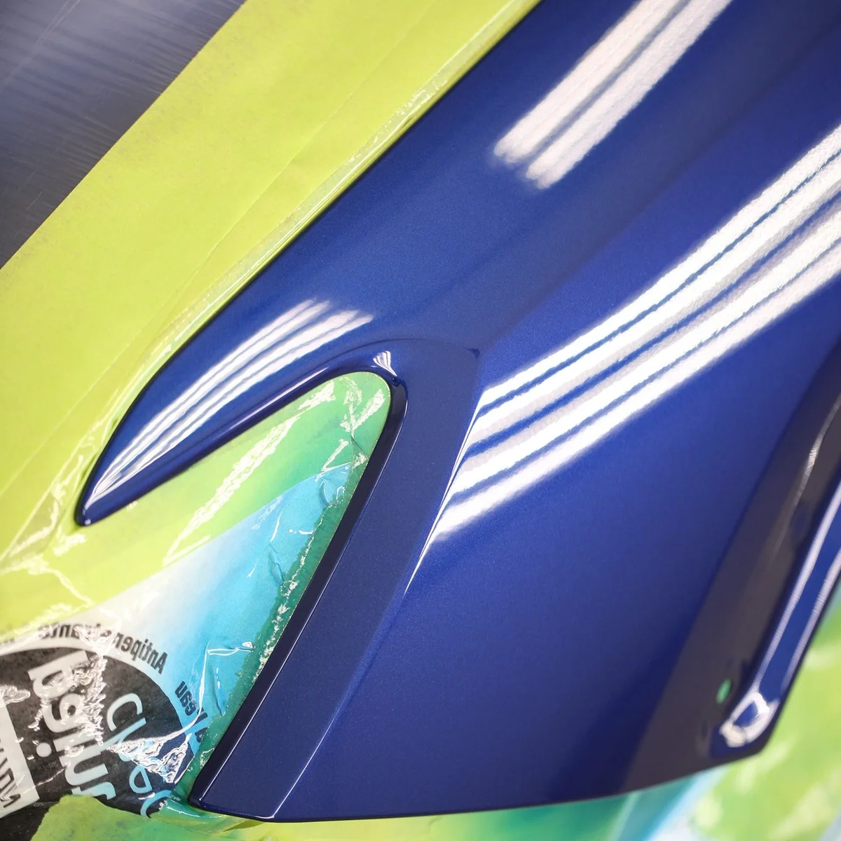 Close-up of a freshly refinished blue vehicle panel